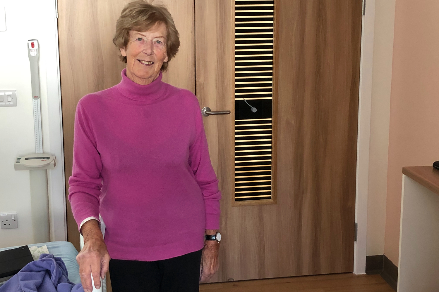 Anne, from the Isle of Man, standing in her hospital bedroom