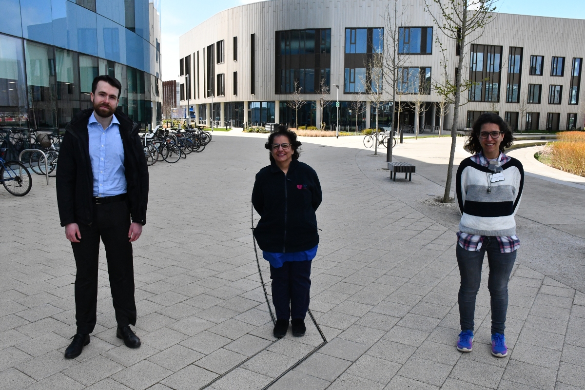 Three people standing outside.