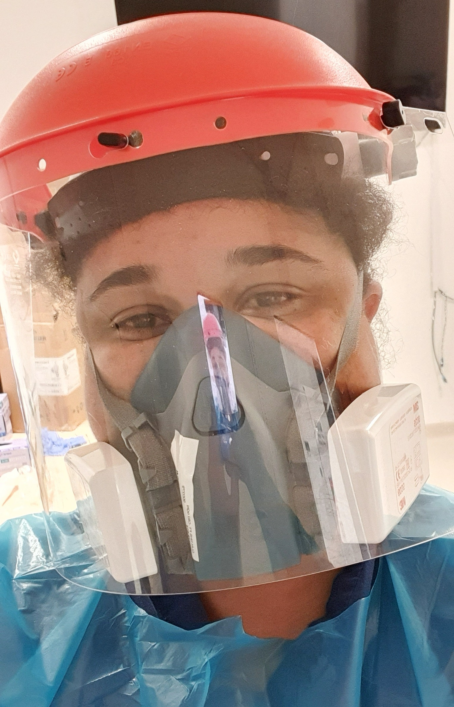 Shorai in full PPE, with a face visor, mask and gown.