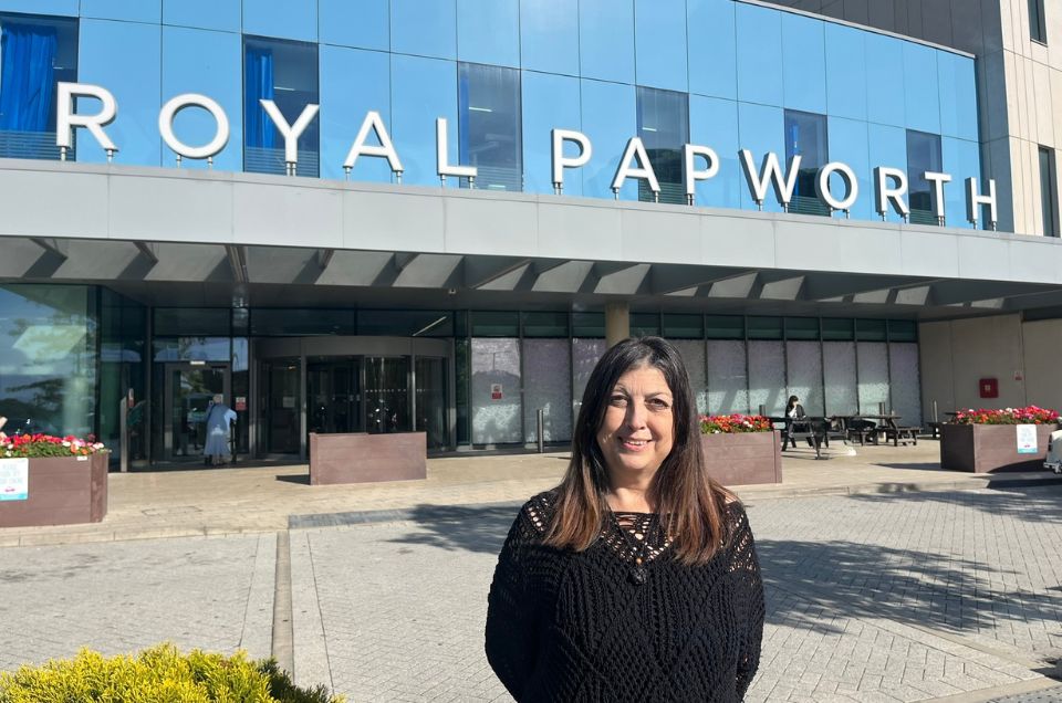 Pam, a heart transplant recipient, smiling outside Royal Papworth Hospital