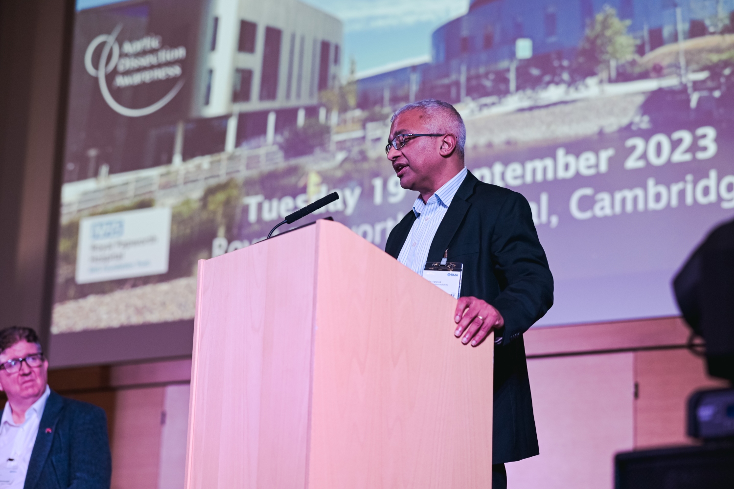 Dr Agrwawl standing on a stage speaking.